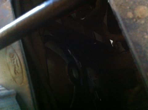 1990 Ford Bronco - A close-up view of a dark vehicle interior, showing structural elements and a circular component.
