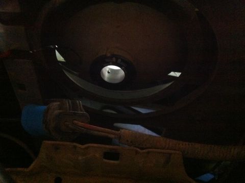 1990 Ford Bronco - Close-up view of a vehicle's headlight housing, showing wiring and a blue connector.
