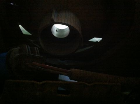 1990 Ford Bronco - Underside view of a vehicle's exhaust system, showing the muffler and pipe.