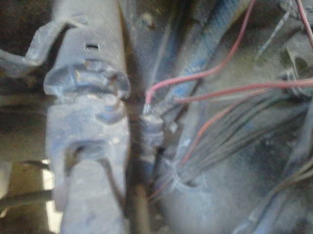 Close-up of wires and mechanical parts in an engine bay