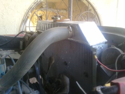 1979 Ford Bronco - Close-up of a vehicle's engine bay, focusing on the radiator and coolant hose.