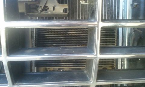 1979 Ford Bronco - The chrome grille bars frame the view of the vehicle's radiator and cooling fins.