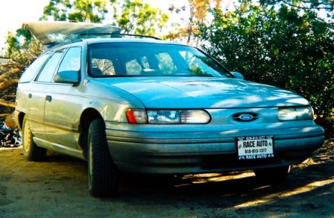 2000 Ford Taurus - Station wagon parked outdoors with rear hatch open. License plate visible.