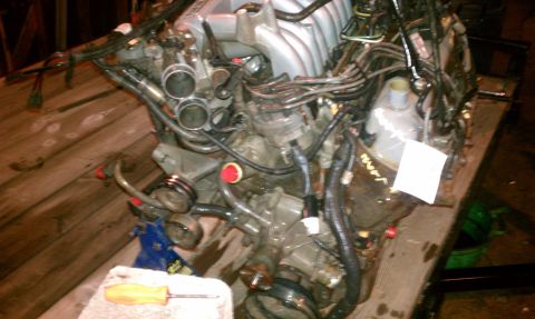 1994 Ford F-250 - This is a close-up view of an engine assembly, possibly undergoing maintenance or repair.