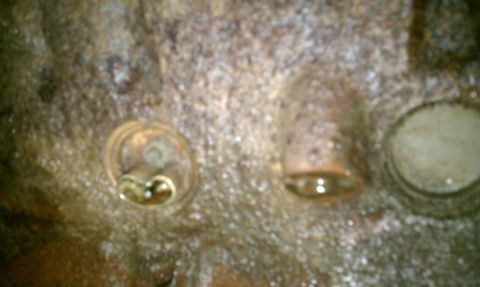 1994 Ford F-250 - This is a close-up view of an engine's cylinder head, showing three of its valve openings.