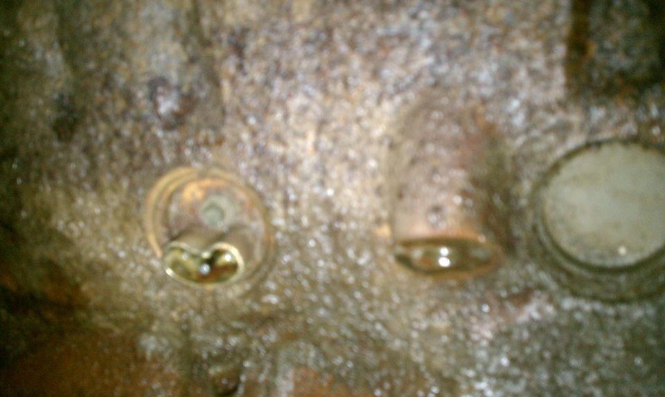 Close-up of an engine cylinder head with three visible valve openings
