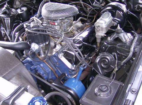 1970 Ford Ranchero - The engine bay of a 1970 Ford Ranchero displays its V8 engine, complete with chrome detailing and an aftermarket air cleaner.