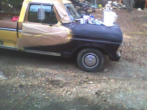 1976 Ford F-150 - Truck is masked off for new paint job, showing the front fender and hood area.
