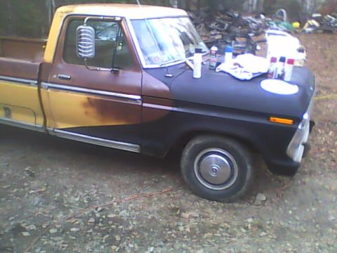 1976 Ford F-150 - This 1976 Ford F-150 is undergoing a paint job, with spray cans visible on the hood.