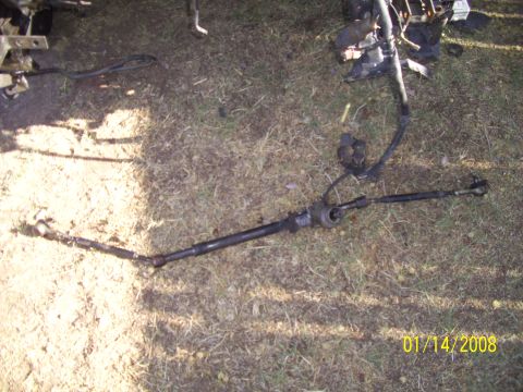 1995 Ford Probe - A car tire rests on the ground, casting a shadow in the sunlight.