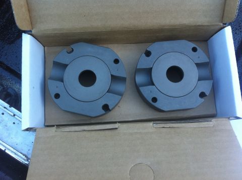1990 Ford Bronco - Two automotive parts are shown in a cardboard box, with a SuperMotors.net watermark visible.