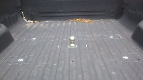 1979 Ford F-150 - The interior of a truck bed is visible, equipped with a fifth wheel hitch for towing.