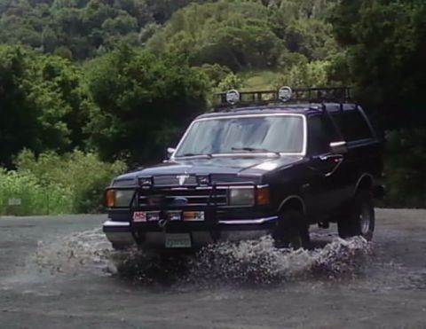 1990 Ford Bronco - This 1990 Ford Bronco is shown driving through a water puddle.