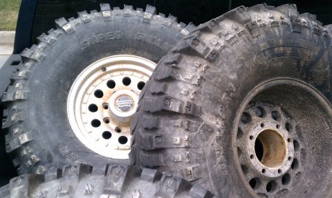 1990 Ford Bronco - Close-up of several large off-road tires and rims, likely for a truck or SUV.