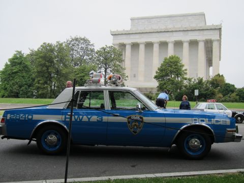 1991 Ford LTD Crown Victoria - blue NYPD Highway Patrol sedan marked HWY 3 with roof speakers is shown in profile before the Lincoln Memorial.