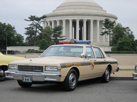 1991 Ford LTD Crown Victoria - tan State Police Chevrolet Caprice with roof lights is parked before the columned domed Jefferson Memorial.