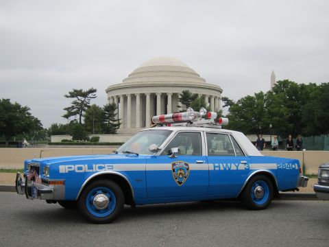 1991 Ford LTD Crown Victoria - two-tone blue NYPD Highway Patrol sedan with roof lights and flags parked in front of the Jefferson Memorial.