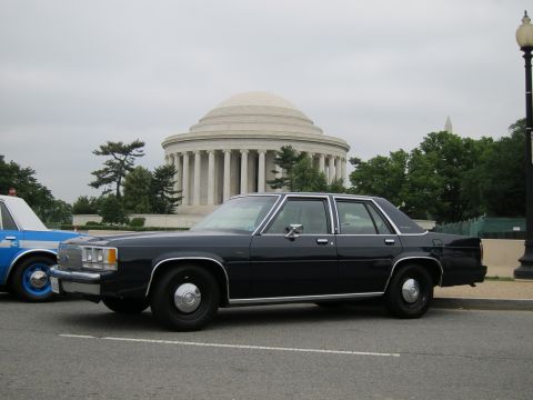1991 Ford LTD Crown Victoria - black Ford LTD Crown Victoria sedan parked near a lamppost in front of the Jefferson Memorial.