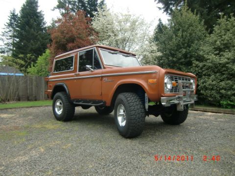 1973 Ford Bronco - A classic 1973 Ford Bronco is shown from a three-quarter front view, parked outdoors on a gravel surface.
