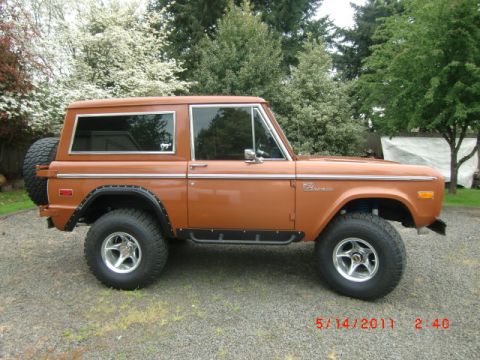 1973 Ford Bronco - This 1973 Ford Bronco is shown in a three-quarter front view, its iconic body style and a spare tire mounted on the back.