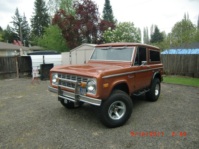1973 Ford Bronco parked on gravel lot. License plate reads GK 233