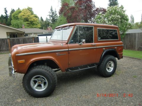 1973 Ford Bronco - This 1973 Ford Bronco is shown from a three-quarter front view, parked outdoors on a gravel surface.