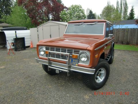 1973 Ford Bronco - This 1973 Ford Bronco is shown from a three-quarter front angle, parked on a gravel surface.