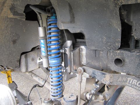 2008 Jeep Wrangler - Close-up of a vehicle's front suspension system, blue coilover shocks and a "KING" shock absorber.
