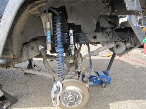 2008 Jeep Wrangler - Jeep Wrangler front suspension components, including shocks and steering stabilizer, are visible.