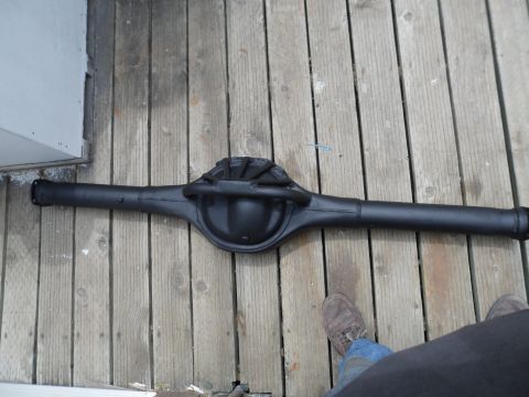 1991 Ford Bronco - A black rear axle assembly rests on a weathered wooden deck.