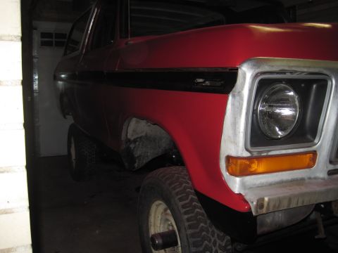 1979 Ford Bronco - This 1979 Ford Bronco features a distinctive red paint job with a black stripe along its side.