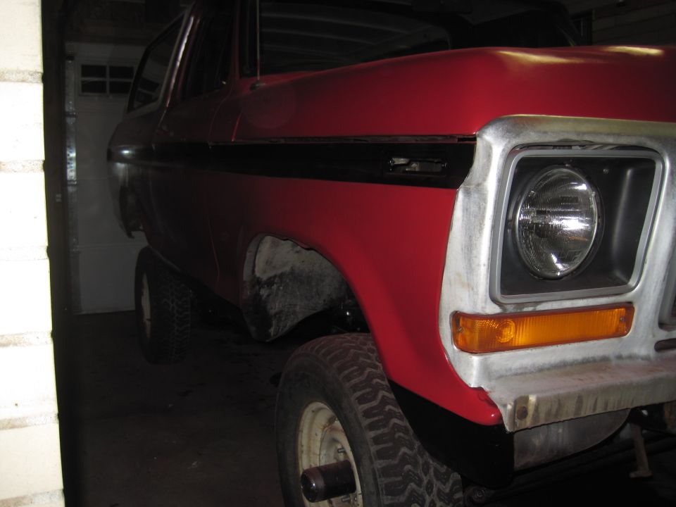 Red 1979 Ford Bronco 3q-front view with black stripe detail
