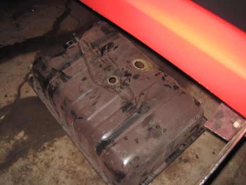 1979 Ford Bronco - A close-up view of a used vehicle fuel tank, showing signs of wear and tear.