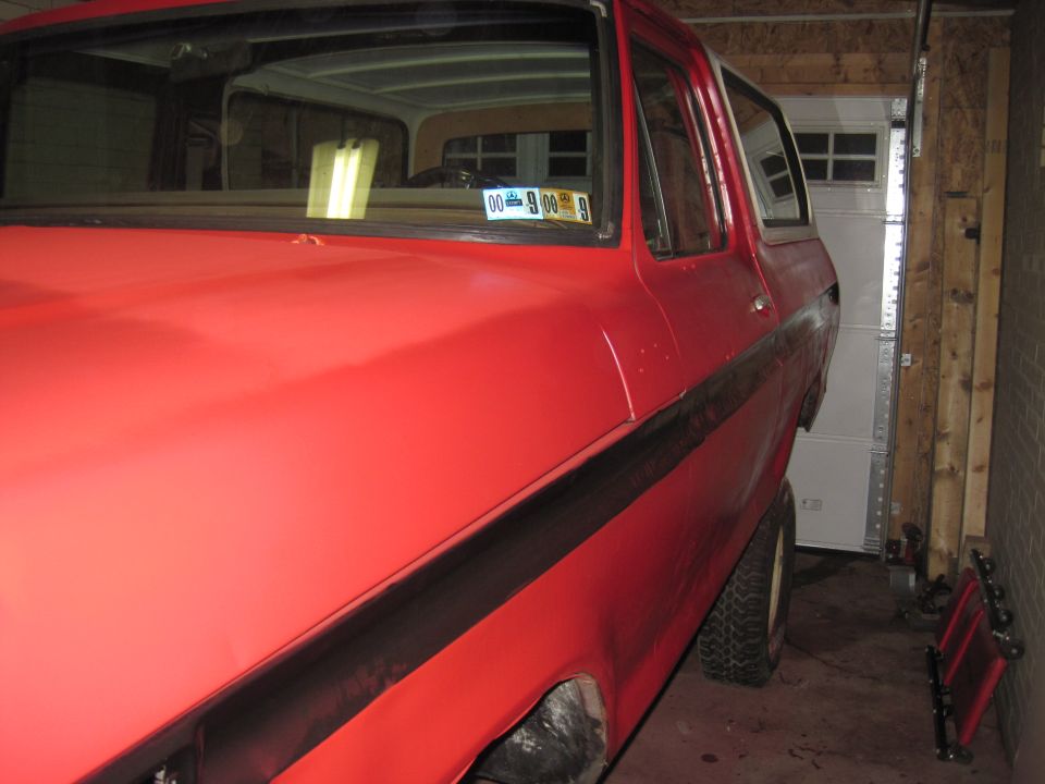 Red 1979 Ford Bronco 3/4 front view in garage