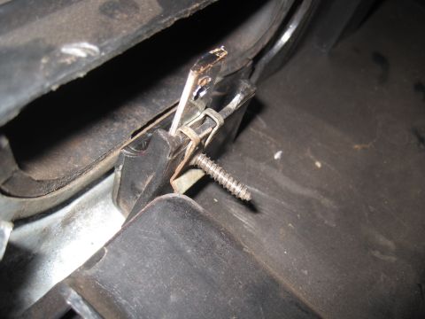 1979 Ford Bronco - Detail of an interior mechanical component, possibly a latch or bracket, with visible screw and clip hardware.