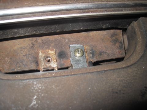 1979 Ford Bronco - Close-up of a rusted metal bracket and screw, likely an interior component.