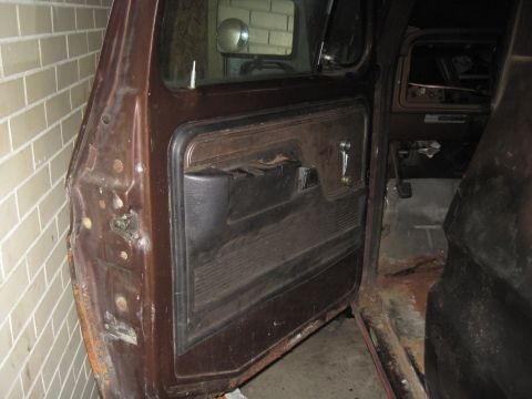 1979 Ford Bronco - Interior view of a 1979 Ford Bronco, focusing on the driver's side door panel and dashboard.