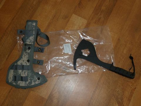 1992 Ford Mustang - A hatchet with a digital camouflage sheath lies next to its packaging on a wooden floor.