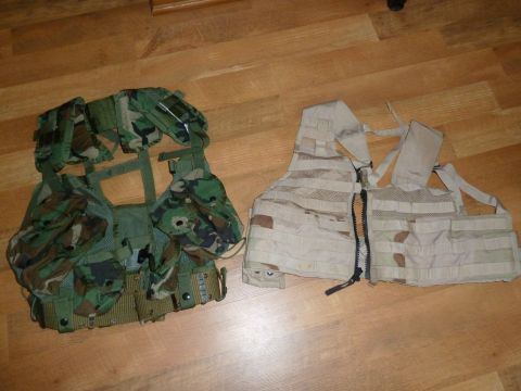 1992 Ford Mustang - Two tactical vests are displayed on a wooden surface, one in woodland camo and the other in desert camo.