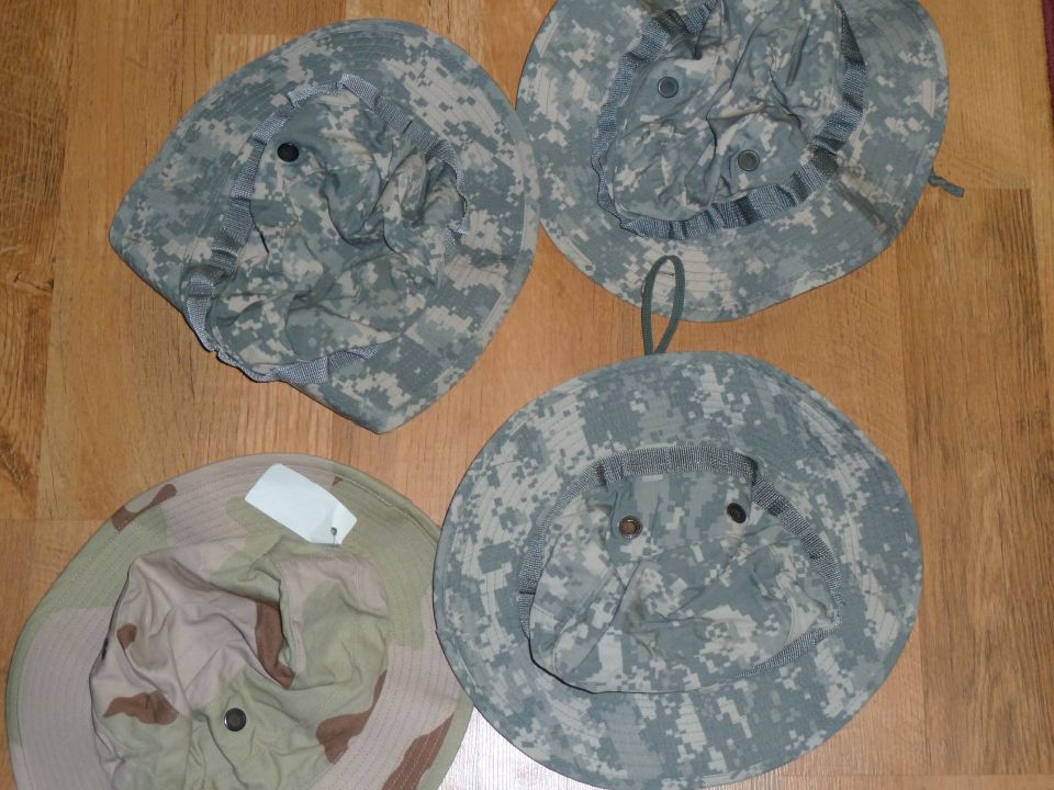 Four camouflage boonie hats, three digital woodland and one desert camo
