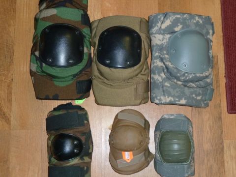 1992 Ford Mustang - A collection of protective knee pads, including woodland camo, tan, and digital camouflage designs, laid out for inspection.