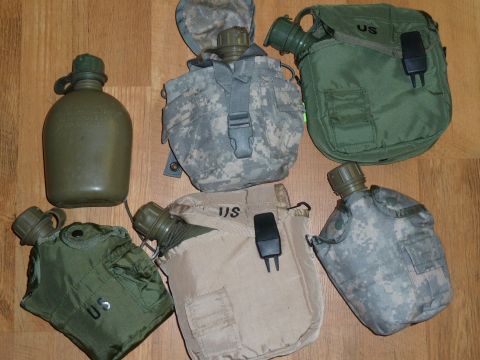 1992 Ford Mustang - Several US military water canteens are arranged on a wooden surface.