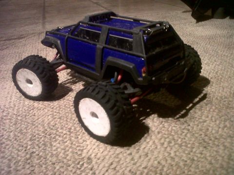 2011 Ford 427 - A blue remote control monster truck sits on a carpeted surface.