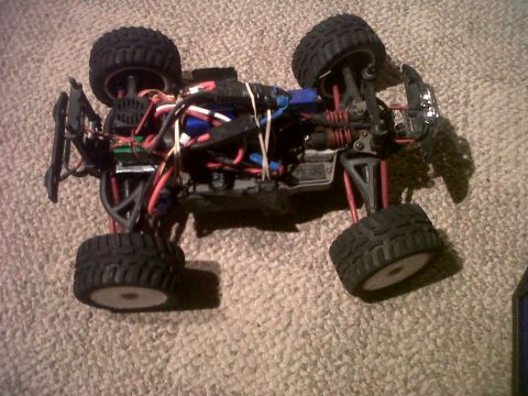 2011 Ford 427 - Chassis of a remote control monster truck, showing suspension and electrical components.
