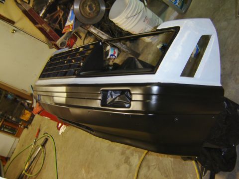 1979 Ford Mustang - Front bumper and grille assembly, possibly from a 1979 Ford Mustang, undergoing restoration.