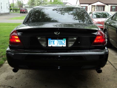 2004 Mercury Grand Marquis - The rear of a black sedan is shown, with a prominent 'Marauder' badge below the license plate.