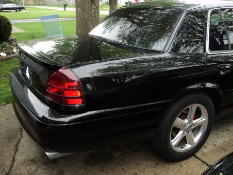 2004 Mercury Grand Marquis - Rear view of a black 2004 Mercury Grand Marquis sedan, showing the taillight and spoiler.