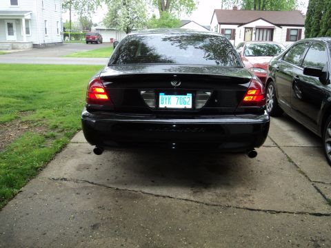 2004 Mercury Grand Marquis - The rear of a black sedan is shown, with a license plate and dual exhaust pipes visible.