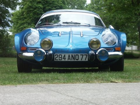 1977 Pontiac Trans Am - A blue Alpine A110 is parked on grass with trees in the background.