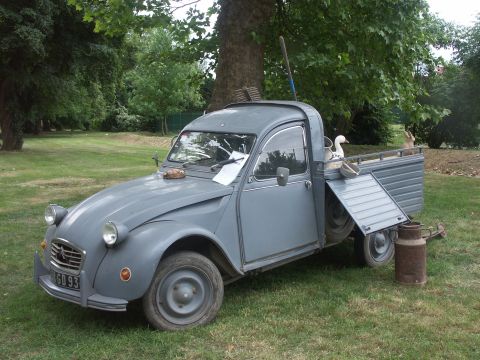 1977 Pontiac Trans Am - This vintage Citroën 2CV pickup truck is parked on a grassy lawn with a decorative duck in its cargo bed.